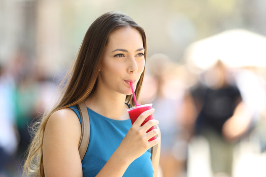 Girl walking and sipping a slush