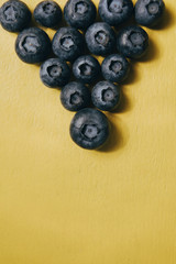 Blueberries on a yellow background