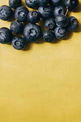 Blueberries on a yellow background