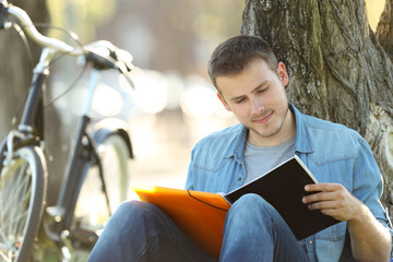 Student studying reading notes outdoors