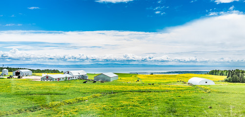 Panorama of Charlevoix region of Quebec Canada with aerial view of farm in summer and Saint...