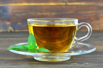 Mint tea in transparent glass cup on white background