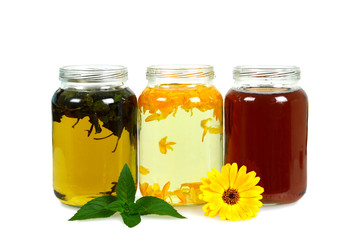 Different tea drinks in the jars isolated on white background
