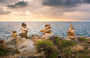 Stacked stones on a beach in Thailand at sunset