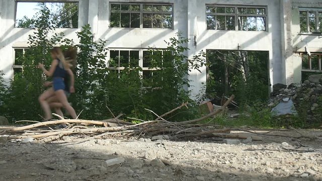 Two young women run away from a mad maniac in an abandoned building