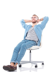 Young man sitting on the chair isolated over white background. Startupper. Young entrepreneur.