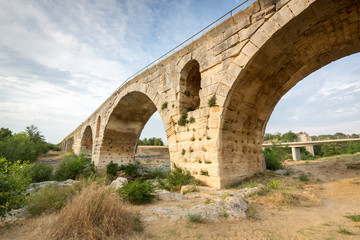 Fototapeta na wymiar Pont Julien - circa 2000 years old Roman stone arch bridge over the Calavon river, Provence, France