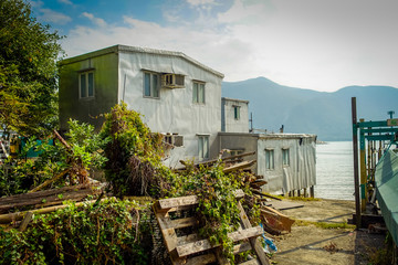 Metallic building used as home in old fishermen village Tai ,with a lake in the horizont, in Hong Kong