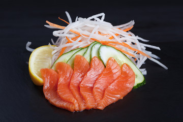 Salmon sashimi served on black slate. Sushi restaurant concept
