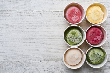 Top view of Ice cream flavors in cup and topping, sweet and dessert food concept