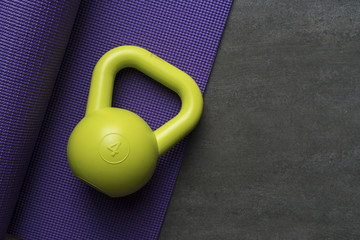Kettlebell and yoga mat on table, fitness healthy and sport concept