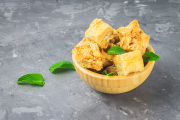 Jewish, turkish, arabic traditional national dessert. Macro. Selective focus. Baklava with honey and nuts