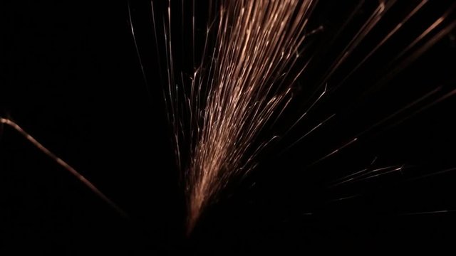Sparks fly out of the darkness. Screensaver or element for special effects. Black color instead of green background.