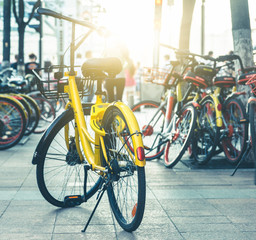 closeup of a shared bicycle parked on sidewalk