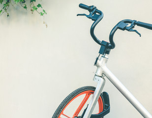 shared bicycle isolated against white wall.
