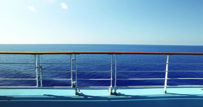 A walking tracking daytime establishing shot looking at the open ocean from the deck of a cruise ship.  	