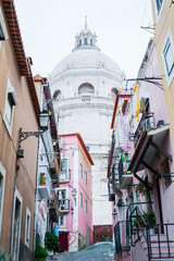 Narrow street in Lisbon with the Pantheon in the background, Protugal