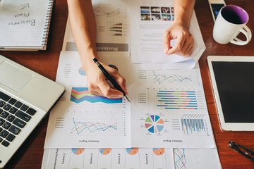 businessman working on project for analyzing company financial report balance statement with documents graphics at modern office space. 