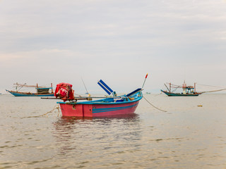 Naklejka na ściany i meble Fishing boats moorn on the bay as tranquil scene of seascape