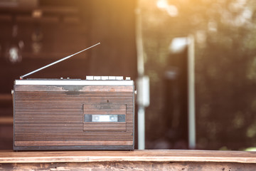 Retro radio cassette stereo on wooden table in vintage color tone
