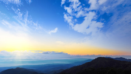 Sunset with sun rays, sky with clouds and sun.