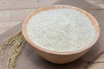 raw rice in wooden bowl
