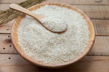 Naklejka na ściany i meble raw rice in wooden bowl