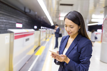 Business woman use of mobile phone in the platform