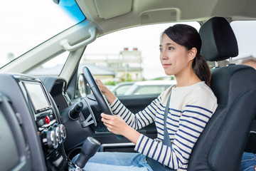 Young woman driving car