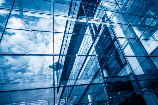 modern glass building with reflection,blue toned.