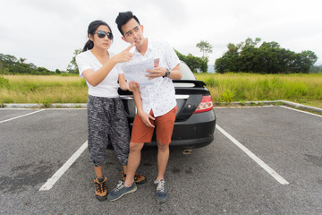 Couple taking a break to look at a map