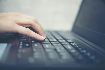 Woman's hand typing with laptop. focus on his finger.