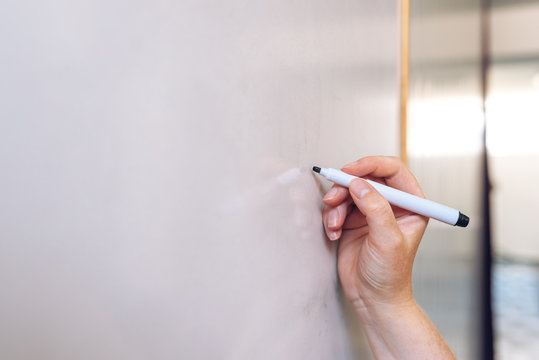 Female Hand Writing On Whiteboard