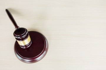 a gavel on a wooden brown desktop, Law, lawyer and justice concept