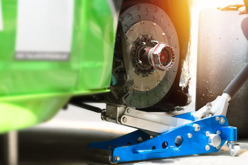 Professional racing team changing tyres at pitstop in Bangsan Thailand.