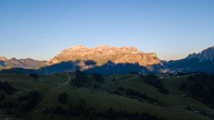 Great landscape on the Dolomites. Drone aerial view on Sella group and Bo peaks during the summer sunrise. Alta Badia, Sud Tirol, Italy