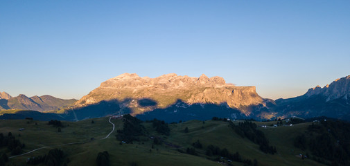 Great landscape on the Dolomites. Drone aerial view on Sella group and Bo peaks during the summer sunrise. Alta Badia, Sud Tirol, Italy