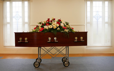 closeup shot of a colorful casket in a hearse or chapel before funeral or burial at cemetery