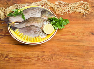 Carp and crucians prepared for cooking on dish