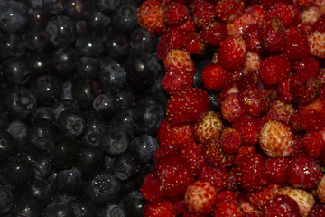 Background of strawberries and blueberries in half