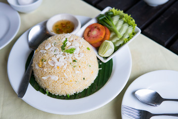 Crab fried rice with vegetables on white plate.