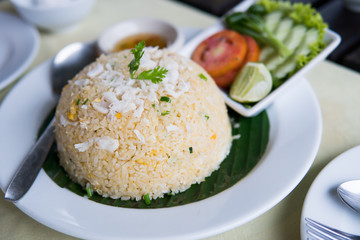 Crab fried rice with vegetables on white plate.