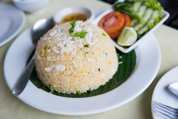 Crab fried rice with vegetables on white plate.