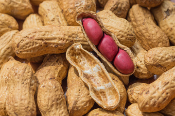 Nut background. Unpeeled peanuts and peeled. Concept of healthy lifestyle