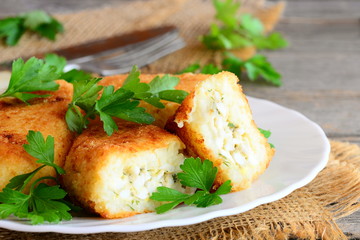 Vegetable cutlets with egg stuffing. Cutlets (zrazy) cooked from cauliflower and potatoes and stuffed with boiled sliced eggs. Rustic style. Closeup
