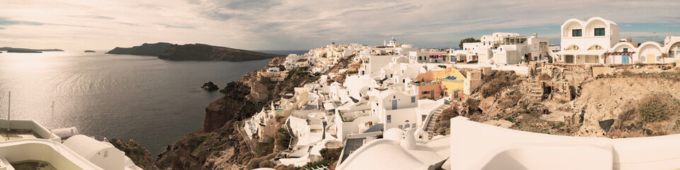 Panorama ofOia town on Santorini island, Greece. Traditional and famous white and rose  houses over the Caldera, Aegean sea