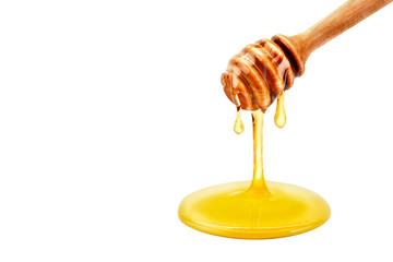 Fresh honey dripping from a spoon. On a white background.