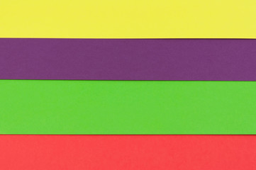 Lines of empty red, green, yellow and violet paper