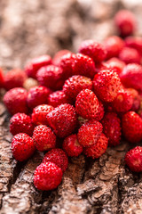 wild strawberries on wooden background.