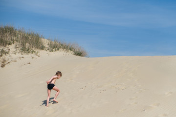 Playful kids on summer beach sand vacation having fun and happy time